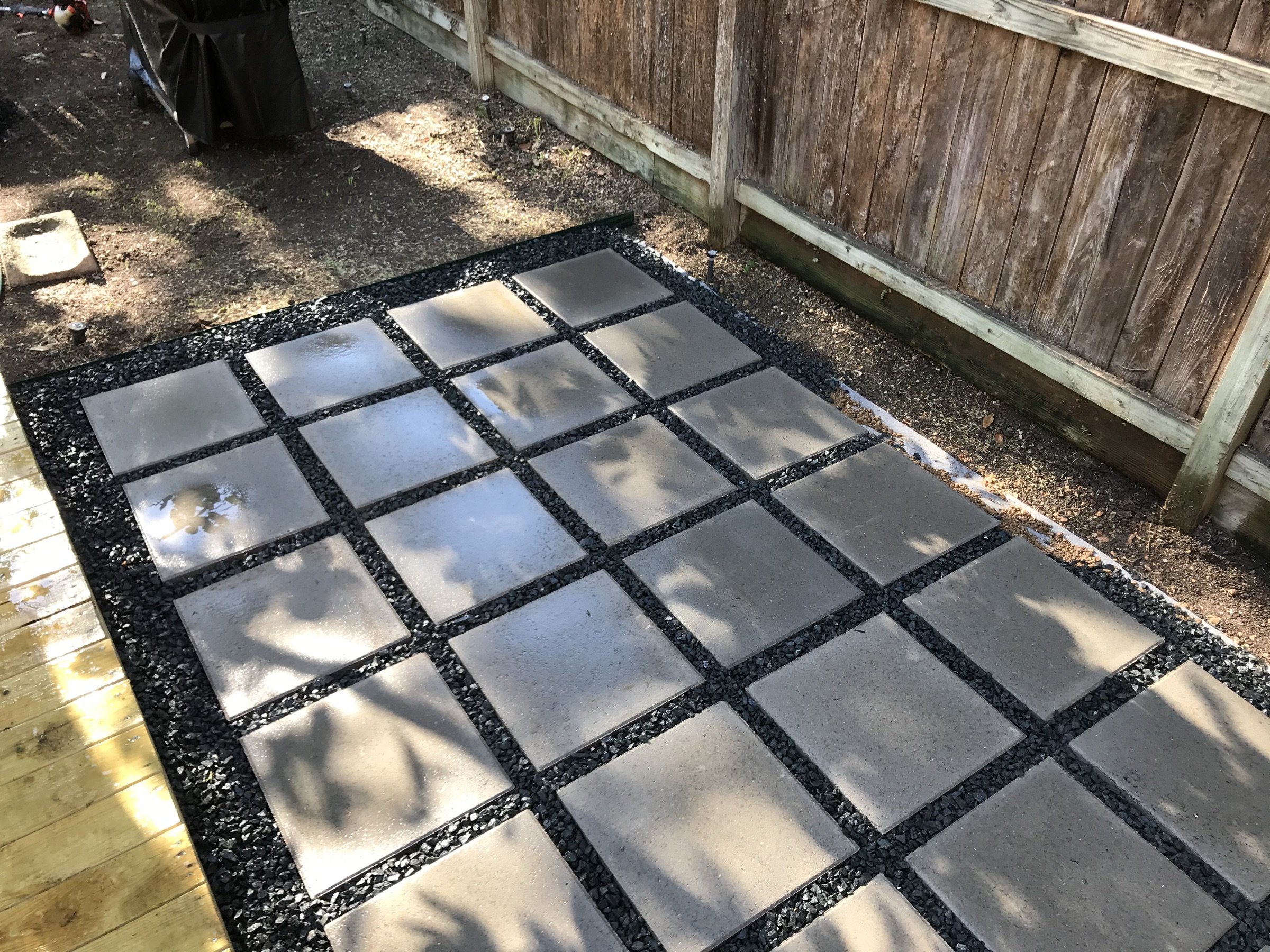 Square pavers set in gravel on a Houston lot