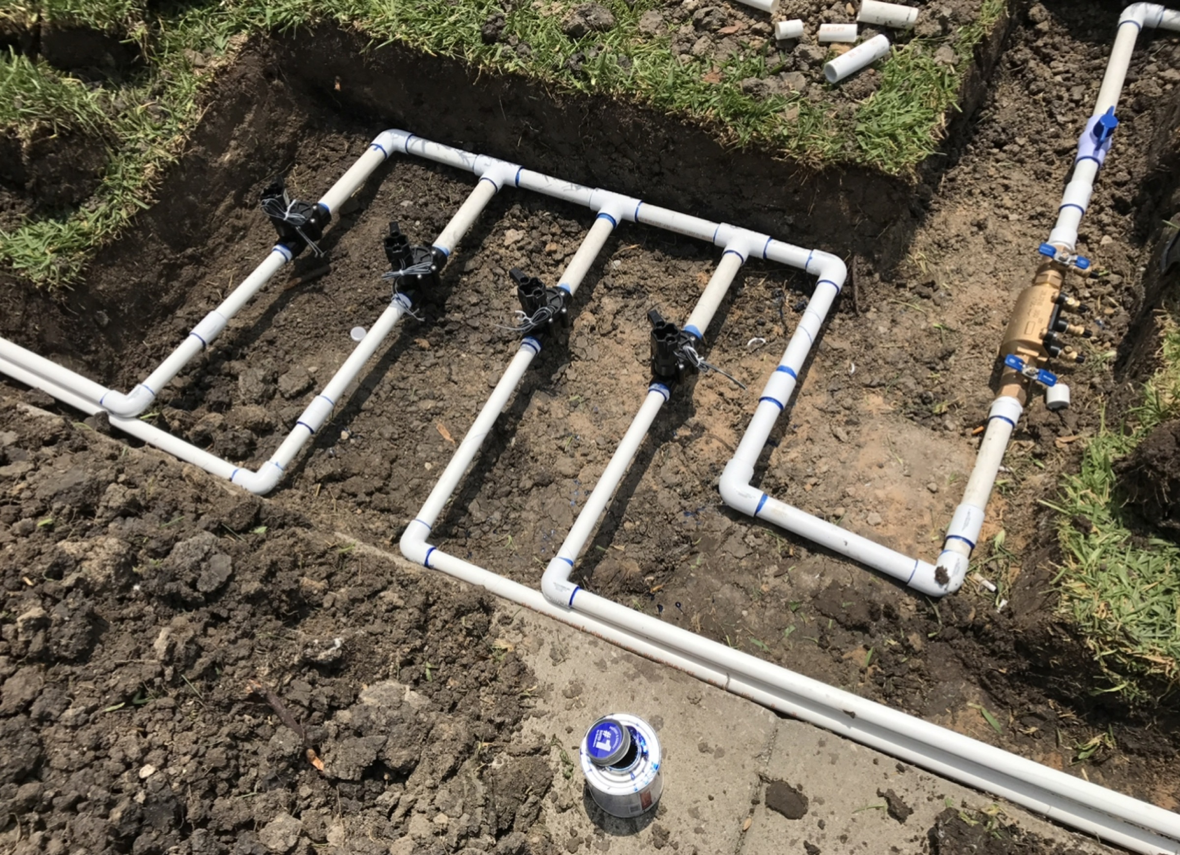 New irrigation manifold and zone piping on a Houston lot