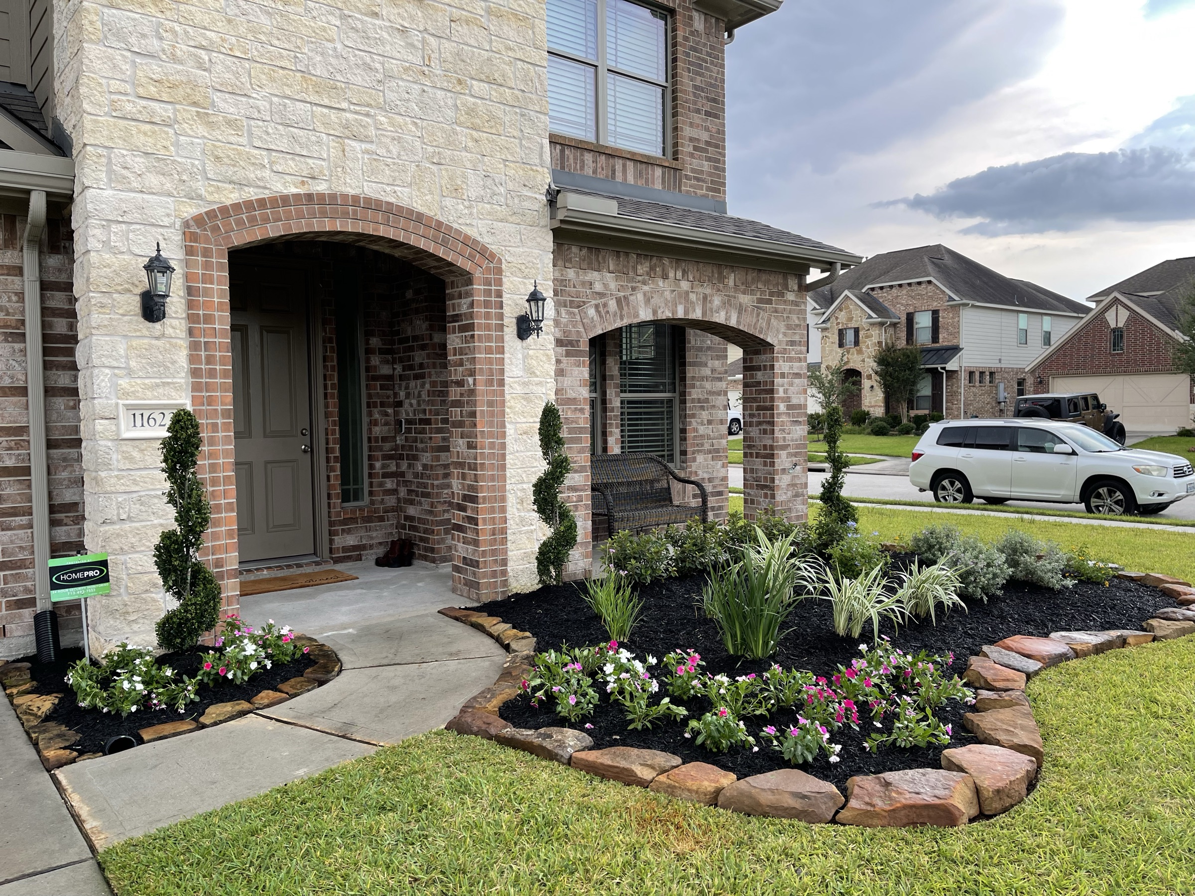 Finished Houston front beds, stone border, and lawn after landscape install